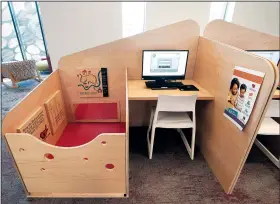  ?? (AP/Richmond Times-Dispatch/Alexa Welch Edlund) ?? A work-and-play station for parents and children is shown Jan. 27 at the Fairfield Area Library in Richmond, Va. The desk has a work station for the parent with a play area attached to it for toddlers or babies outfitted with a vinyl cushion and built-in play features like a mirror and holes for playing peek-a-boo.