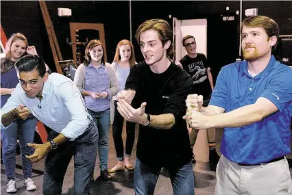  ?? Photo credit ?? The Woodlands High School Improv Troupe members Omar Saber, left, and Will Burke work with theater director Matthew Peters during a rehearsal in the school’s black box theater. The group will perform at 7 p.m. tonight at the school’s auditorium.