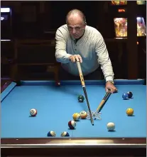  ?? PETE BANNAN - MEDIANEWS GROUP ?? Jon Parsons uses a bridge shot at Drexeline Billiard Club which will be moving with the redevelopm­ent.