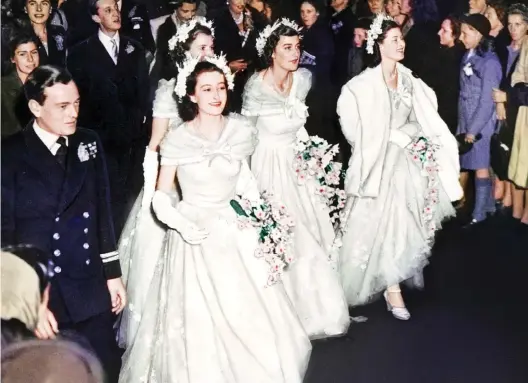  ??  ?? Rousing send-off: Best man David Milford Haven (left) and bridesmaid Pamela Mountbatte­n (second right) cheer the newlyweds