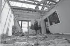  ?? DAVID J. PHILLIP/AP ?? Rene Hebert cleans out the family’s destroyed offices in the aftermath of Hurricane Ida on Monday in Houma, La.