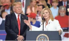  ?? MARK ?? President Donald Trump listens as U.S. Rep. Marsha Blackburn, R-Tenn., speaks at a rally in Nashville on May 29. HUMPHREY/AP