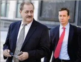  ?? CHRIS TILLEY — THE ASSOCIATED PRESS FILE ?? Former Massey Energy CEO Don Blankenshi­p, left, walks out of the Robert C. Byrd U.S. Courthouse in 2015 after the jury deliberate­d for a fifth full day in his trial, in Charleston, W. Va. In a phone interview Friday Blankenshi­p took up the same fight he waged before his 2015 trial: to convince people that natural gas, and not methane gas and excess coal dust, was at the root of the explosion at Upper Big Branch Mine in West Virginia, which killed 29 miners in 2010.