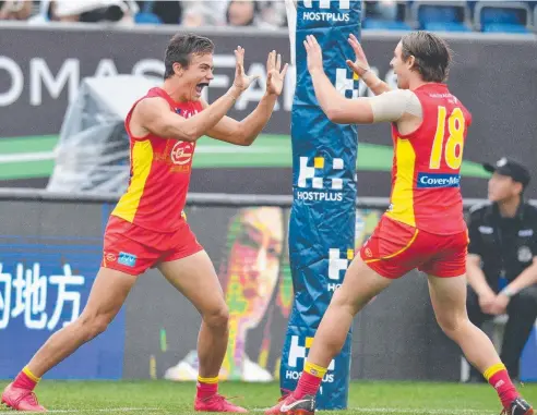  ?? Picture: AAP IMAGE ?? DREAM DEBUT: Jacob Heron of the Suns celebrates a goal with Brad Scheer during the Round 9 AFL match between Gold Coast and the Port Adelaide Power at Jiangwan Stadium in Shanghai, China, on Saturday.