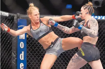  ?? JIM YOUNG/ASSOCIATED PRESS ?? Holly Holm, left, is shown fighting Megan Anderson in 2018. Saturday, Holm faces Raquel Pennington at UFC 246.