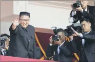  ??  ?? North Korean soldiers march during a parade for the 70th anniversar­y of the nation’s founding day; leader Kim Jong-un waves after a parade in the capital Pyongyang