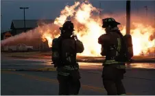  ?? FILE PHOTO ?? Firefighte­rs stand and watch during a natural gas fire that occurred in Farmington on Dec. 16. The fire burned for more than eight hours.