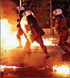  ??  ?? Chaos: Riot police facing anti-austerity protests in Greece