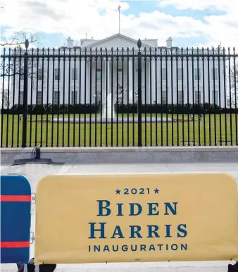  ?? ERIC BARADAT/AFP VIA GETTY IMAGES ?? Banners announcing the inaugurati­on of President-elect Joe Biden and Vice President-elect Kamala Harris are displayed outside the White House on Tuesday.