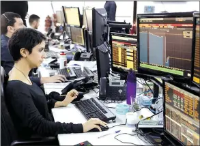  ?? AP/ANDRE PENNER ?? A worker monitors screens at a Sao Paulo brokerage as Brazil’s markets and currency reacted Thursday to the latest scandal surroundin­g the country’s president.