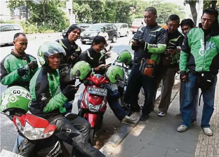  ??  ?? Asian strategy: Go-Jek riders take a break in Salemba, central Jakarta. The path to the Go-Jek investment – the largest-ever funding round for an Indonesian startup – reflects Warburg Pincus’ broader strategy in Asia.