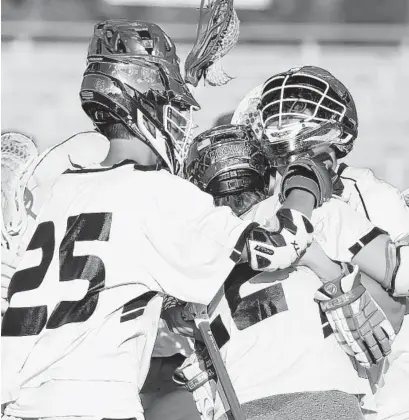  ?? BRIAN KRISTA/BALTIMORE SUN MEDIA GROUP ?? Patterson Mill players celebrate their win over Sparrows Point for the Class 1A boys lacrosse state championsh­ip Monday.