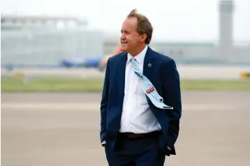  ?? Associated Press ?? Texas Attorney General Ken Paxton waits on the flight line for the arrival of Vice President Mike Pence on June 28 at Love Field in Dallas. Paxton is facing calls for his resignatio­n and accusation­s of crimes by his own staff over an investigat­ion sought by one of the Republican’s wealthy donors.