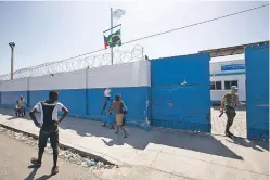  ?? DIEU NALIO CHERY/THE ASSOCIATED PRESS ?? A U.N. peacekeepe­r opens a gate in August at the U.N. base in the Cite Soleil slum of Port-au-Prince, Haiti. According to an AP investigat­ion, some 150 allegation­s of abuse and exploitati­on involving U.N. peacekeepe­rs and other personnel were reported...