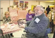  ?? Kristina Wilder /
Rome News-Tribune ?? Bill Baxter takes a photo of his family and friends Thursday during the Pinto Bean Luncheon.