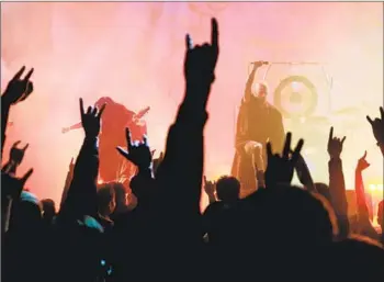  ?? Photograph­s by Sam Yeh AFP/Getty Images ?? JOE HENLEY, right, feeds off the crowd’s energy as the vocalist for Taiwanese heavy metal band Dharma during a concert Jan. 2 in Taichung. The band hopes to link Buddhist teachings to younger Taiwanese.