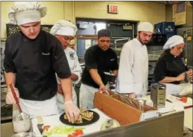  ?? DIGITAL FIRST MEDIA FILE PHOTOS ?? Pottstown High School culinary students compete in the Grumpy’s Chopped Challenge preparing a variety of heart healthy sandwiches.