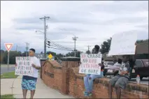  ??  ?? From left, Octavia Ford, Malia Speight and Jayden Bowman hold up signs to protest against high-speed police chases and runs in the tri-county area.