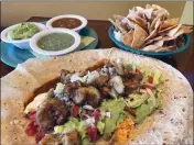  ?? PHOTOS BY SHERRY LAVARS — MARIN INDEPENDEN­T JOURNAL ?? A shrimp burrito with rice, beans, lettuce, pico de gallo and spicy habanero lime at Taquería and Pupusería El Torogoz in Larkspur. Served with a side of tortilla chips, salsa guacamole and habanero sauce for dipping.