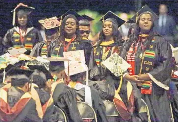  ?? John Raoux Associated Press ?? GRADUATES at Bethune-Cookman University in Daytona Beach, Fla., turn their backs on Education Secretary Betsy DeVos’ commenceme­nt speech. Many students at black colleges see the White House as insensitiv­e.