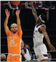  ?? (AP/Sam Craft) ?? Tennessee guard Santiago Vescovi (left) makes a three-pointer as Texas A&M guard Quenton Jackson defends during the first half Saturday in College Station, Texas. Vescovi scored a career-high 23 points, including six three-pointers, to lead the No. 9 Volunteers to a 68-54 victory.
