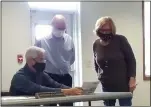  ?? ZACHARY SRNIS — THE MORNING JOURNAL ?? Lorain County Board of Elections members Anthony Giardini, left, Democrat, Marilyn Jacobcik, Chair, Republican, right, along with Paul Adams, director, look over a ballot with a signature issue.