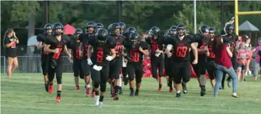  ??  ?? ■ Cutter Morning Star run onto the field prior to their Aug. 30, 2019, game against Bismarck at Eagle Field. Head coach Matt Kinsinger announced that the program is shifting to eight-man football for the 2021-2022 and 2022-2023 seasons.