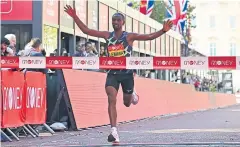  ?? AFP ?? Ethiopia’s Sisay Lemma crosses the finish line to win the London Marathon.