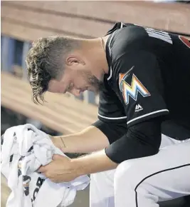  ?? LYNNE SLADKY/AP ?? Pitcher Justin Nicolino, here in the dugout last Saturday, has been taken out of the starting rotation by manager Don Mattingly.