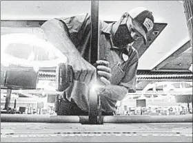  ?? WAYNE PARRY/AP ?? Dean Loveland, a Hard Rock casino worker in Atlantic City, N.J., recently installs barriers.