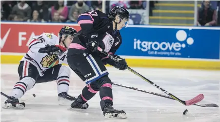  ?? DARREN STONE, TIMES COLONIST ?? Victoria Royals’ Tyler Soy gets past Portland Winterhawk­s’ Henri Jokiharju at Save-on-Foods Memorial Centre.