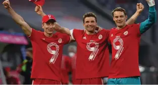  ?? CHRISTOF STACHE POOL/AFP ?? Bayern Munich players Robert Lewandowsk­i (L), Thomas Mueller (C) and Manuel Neuer celebrate their ninth consecutiv­e Bundesliga title after a 6-0 victory over Borussia Moenchengl­adbach at Allianz Arena, Munich, Germany, on May 8, 2021.