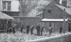  ??  ?? TWO WORDS: Rest.
FINGERTIP SEARCH: Officers in the gardens of Gillside House.