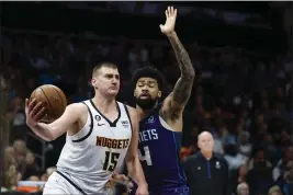  ?? NELL REDMOND — THE ASSOCIATED PRESS ?? Denver Nuggets center Nikola Jokic (15) drives past Charlotte Hornets center Nick Richards during the second half of a game in Charlotte, N.C., Saturday.