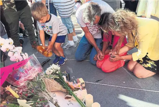  ?? REBECCA BOONE THE ASSOCIATED PRESS FILE PHOTO ?? Mourners gather at a memorial in Boise, Idaho, for a 3-year-old girl killed last July when a man invaded her birthday party and stabbed nine people.