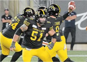  ?? JOHN RENNISON HAMILTON SPECTATOR FILE PHOTO ?? Mike Filer (51) blocks for quarterbac­k Dane Evans in August 2019.