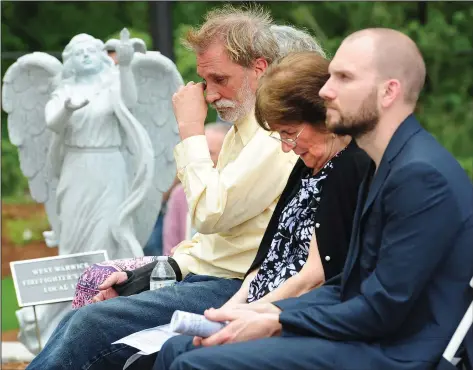  ?? Photos by Ernest A. Brown ?? Bruce Cain, of Warwick, left, wipes away a tear during a reading of the 100 victims’ names during the Station Fire Memorial Foundation’s Memorial Service at the memorial site on Sunday. Cain lost his girlfriend, Tina Ayer, in the fire that night 15...