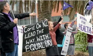  ?? PHOTO: MONIQUE FORD/STUFF ?? New Zealand Nurses Organisati­on president Grant Brookes, left, and midwife Sarah Gibertson, middle, at yesterday’s rally outside Wellington Hospital in Newtown.