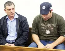  ??  ?? Shlomo Filber, left, sits at the Magistrate Court during his remand in Tel Aviv, Israel, on Feb. 18. (Reuters)