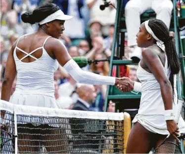  ?? Ben Stansall / AFP/Getty Images ?? After losing 6-4, 6-4 in the first round Monday, Venus Williams, left, congratula­tes 15-year-old Cori Gauff, who said she told Williams: “Thank you for everything that you did. I wouldn’t be here without you.”