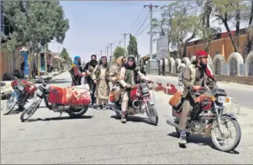  ??  ?? ‘HERE WE COME’: Taliban fighters patrol the streets of Ghazni city in Afghanista­n on Thursday.