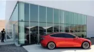  ?? JAMES GLOVER/REUTERS ?? A prototype of the Tesla Model 3 is displayed during a media tour of Tesla’s Gigafactor­y 1. Tesla hopes to produce batteries for 500,000 cars in 2018.