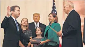  ?? AFP ?? Brett Kavanaugh (left) is sworn in at the White House as US President Donald Trump looks on.