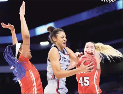  ?? Carmen Mandato / Getty Images ?? UConn’s Olivia Nelson-Ododa grabs a rebound against Syracuse’s Kamilla Cardoso and Digna Strautmane (45) in the first half during the second round of the NCAA tournament at the Alamodome on Tuesday in San Antonio.