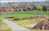  ?? JIM THOMPSON/JOURNAL ?? Piles of dirt line a paved pathway in what was once the north nine holes of the Club Rio Rancho golf course. Pulte Homes announced in May that it planned to develop about 180 homes.