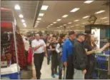  ?? KEITH REYNOLDS — THE MORNING JOURNAL ?? Cleveland Indians fans pile into Dick’s Sporting Goods, 360 Market Drive in Elyria, to try and get their hands on some of the team’s American League Championsh­ip apparel.