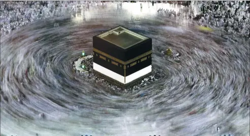  ?? KARIM SAHIB / AGENCE FRANCE-PRESSE ?? This long exposure photograph shows Muslim pilgrims walking around the Kaaba, Islam's holiest shrine, at the Grand Mosque in Saudi Arabia's holy city of Mecca on Sunday prior to the start of the annual hajj pilgrimage.