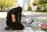  ?? Jay Janner / Associated Press ?? Iliana Calles prays at the Governor’s Mansion in Austin after the mass school shooting in Uvalde.