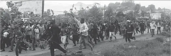  ?? AFP/GETTY IMAGES ?? Demonstrat­ors march during a protest against perceived discrimina­tion in favour of the country’s francophon­e majority in anglophone hub Bamenda, Cameroon, last year. President Paul Biya has reacted to their demands for an anglophone homeland with a curfew for English-speaking areas and violence from the military.