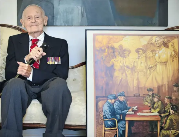  ?? ED KAISER/ EDMONTON JOURNAL ?? Dr. George Molnar is depicted on this poster in his Edmonton home. He’s on the right side of the table, seated and wearing the beret.